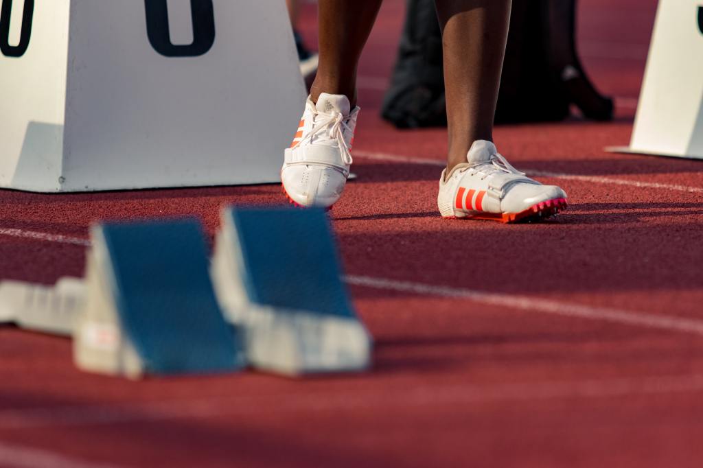 The feet of an athlete in a running track